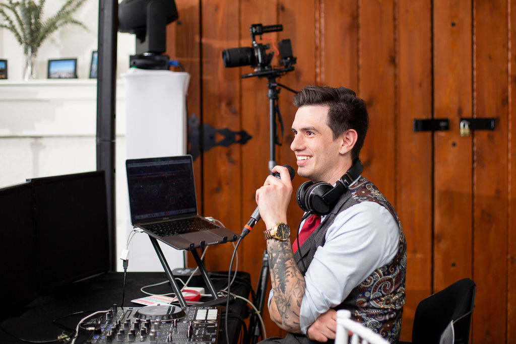 a man is speaking in a mike, The Importance of a Do-Not-Play List, Most Important Questions to Ask Your Wedding DJ